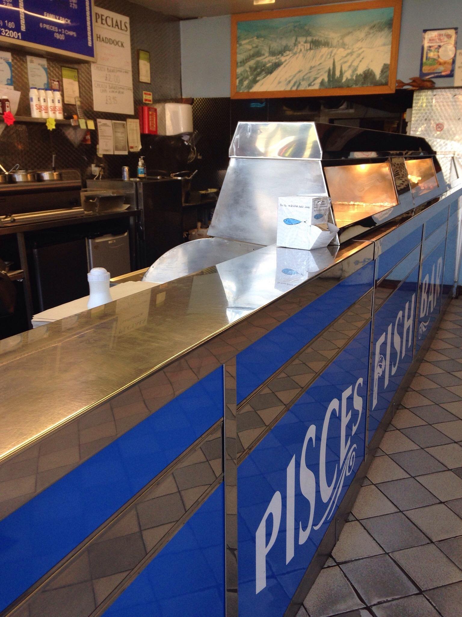 Fresh fish and chips at Pisces Fish Bar, Wickford's traditional chip shop kitchen and counter